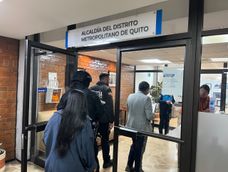 Funcionarios de Fiscalía y agentes policiales entrando al despacho de la Alcaldía de Quito para ejecutar un allanamiento.